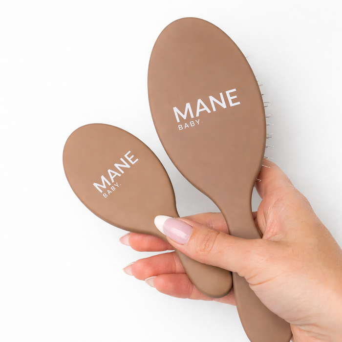 The Mane Baby Original and Mini brushes held together, branded backs facing up