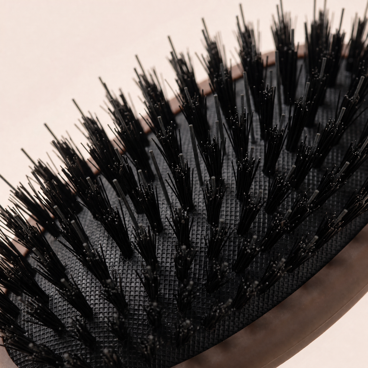 Close-up of the Mane Baby Original Boar Bristle Brush cushion pad, showing dense boar bristle tufts